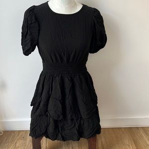 Black ruffled dress with cutout in the back.
